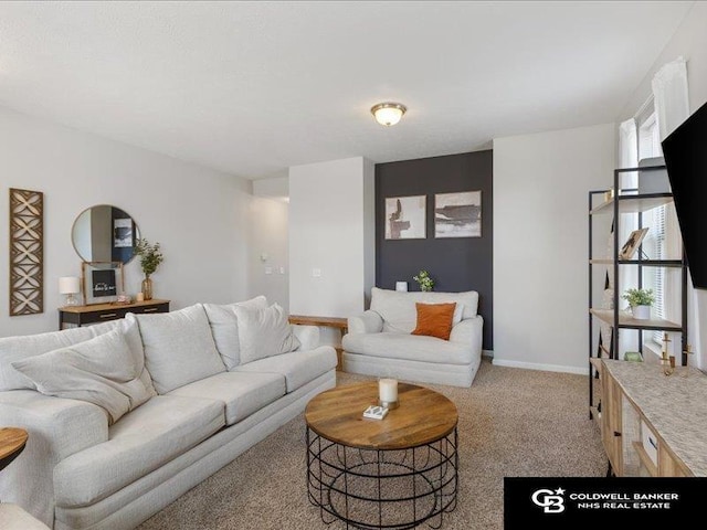 living room featuring baseboards and light colored carpet