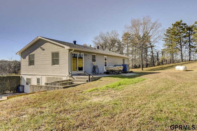 rear view of property with a patio and a yard