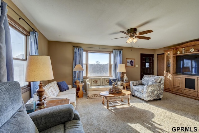 living area featuring ceiling fan and carpet flooring