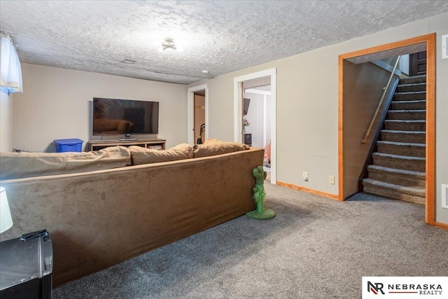 living area featuring visible vents, baseboards, stairway, a textured ceiling, and carpet