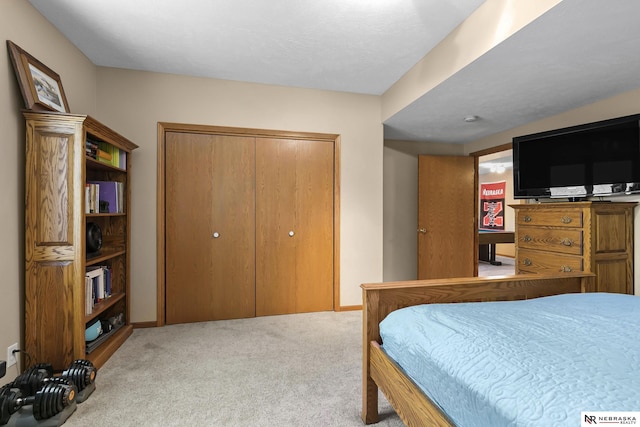 bedroom with carpet floors, baseboards, and a closet