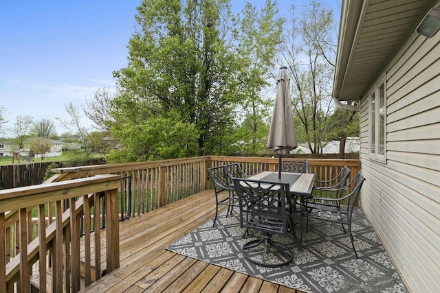 deck featuring fence and outdoor dining space