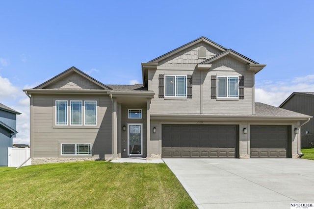 view of front of property with fence, an attached garage, a shingled roof, a front yard, and concrete driveway