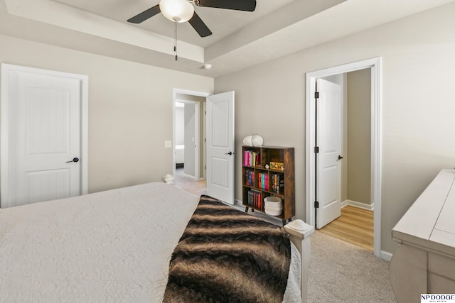 bedroom featuring baseboards, ceiling fan, and light colored carpet