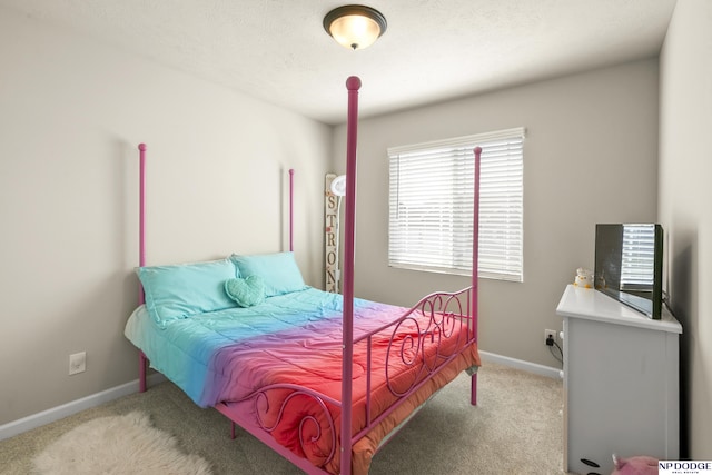 carpeted bedroom with baseboards