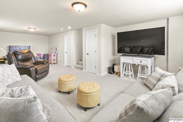 living room with carpet floors, baseboards, and stairway