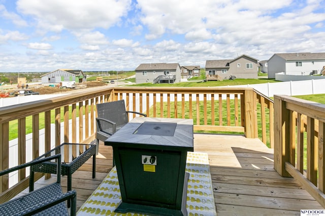 wooden terrace featuring a yard and a residential view