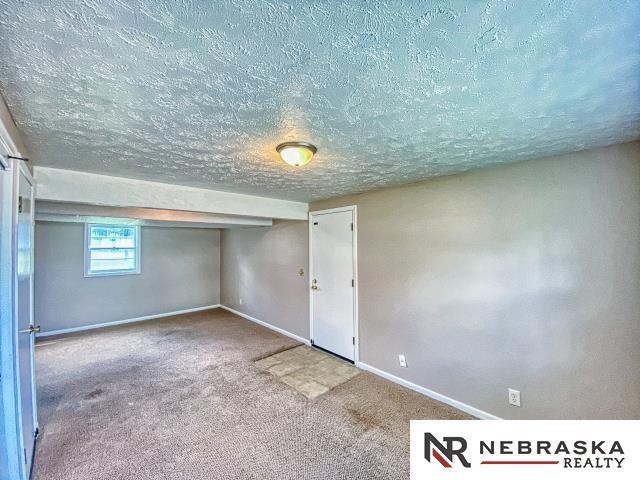 interior space featuring baseboards and a textured ceiling