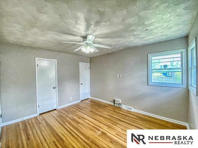 unfurnished bedroom featuring baseboards, ceiling fan, and wood finished floors