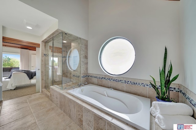 ensuite bathroom with connected bathroom, a bath, and a tile shower