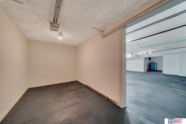 garage with baseboards and a garage door opener