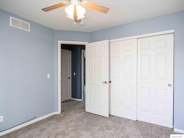 unfurnished bedroom with carpet floors, a closet, ceiling fan, and baseboards