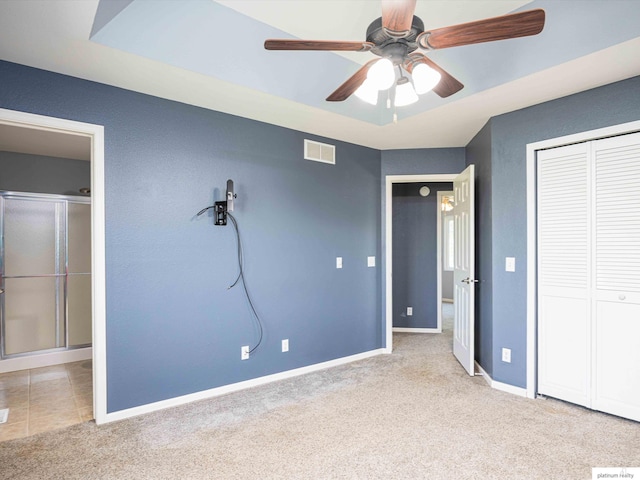 unfurnished bedroom with carpet floors, baseboards, and a closet
