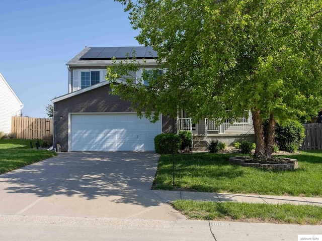 obstructed view of property with driveway, roof mounted solar panels, an attached garage, and covered porch