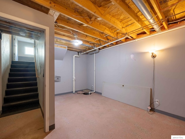below grade area with stairway and baseboards