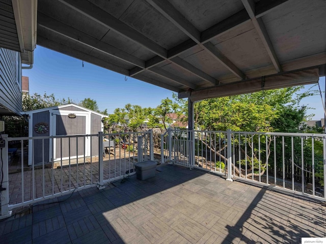 view of patio / terrace with a shed and an outbuilding