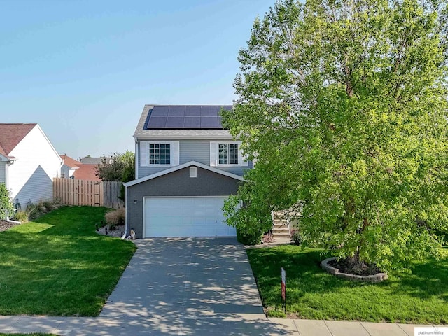 view of front of property featuring driveway, solar panels, and roof with shingles