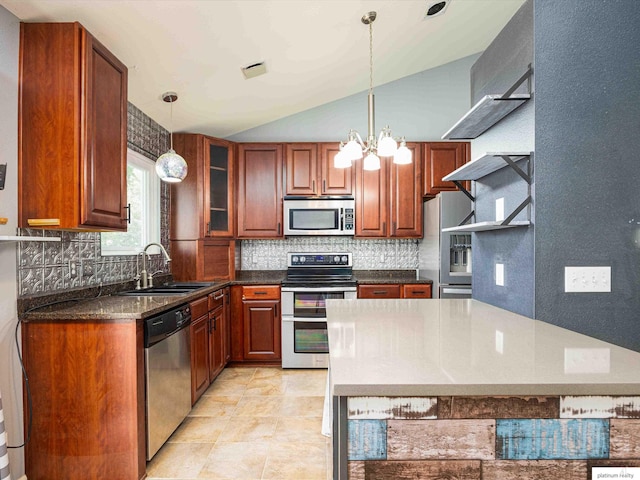 kitchen featuring appliances with stainless steel finishes, a sink, decorative backsplash, lofted ceiling, and hanging light fixtures