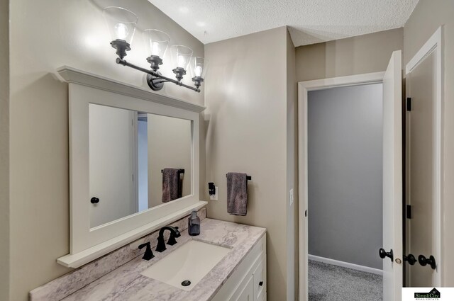 bathroom with a textured ceiling and vanity