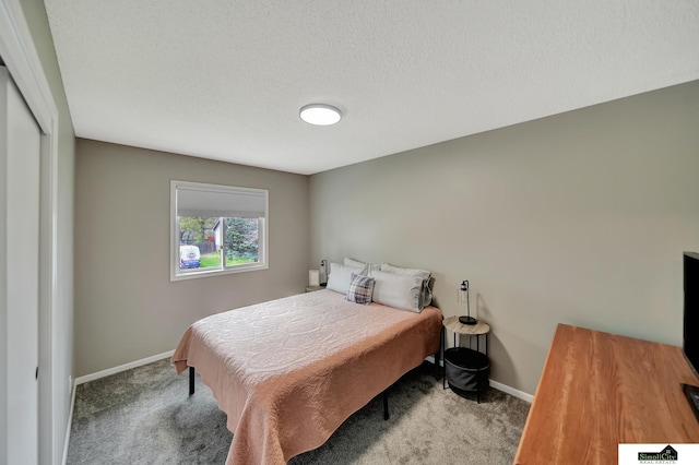 bedroom with baseboards and carpet
