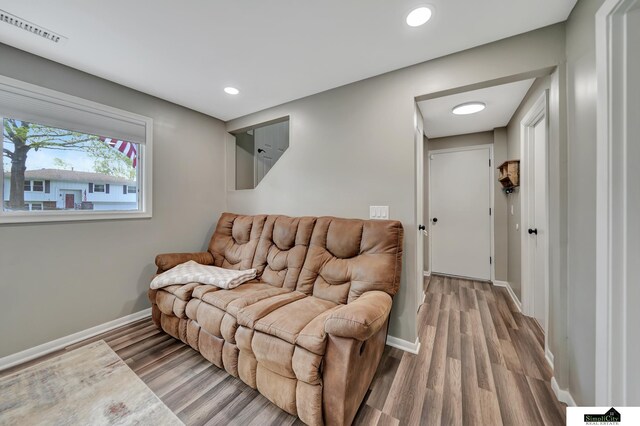 living area with recessed lighting, baseboards, visible vents, and light wood-style floors