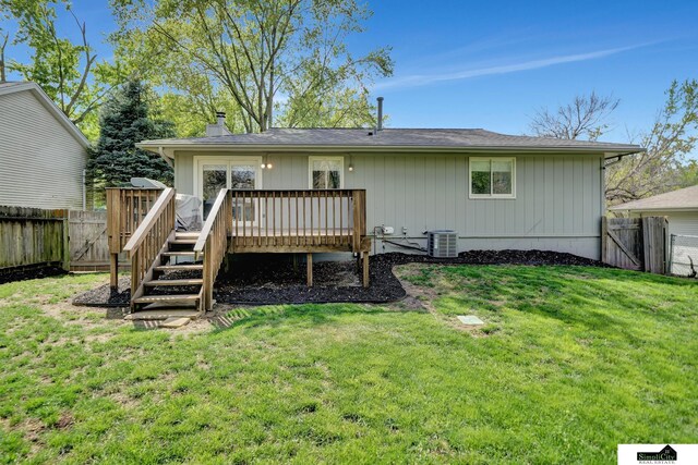 back of property with a fenced backyard, a gate, a deck, and cooling unit