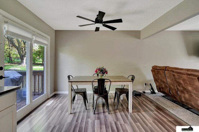 dining room with baseboards, a ceiling fan, and light wood-style flooring