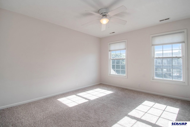 empty room with carpet, baseboards, and a ceiling fan