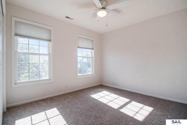carpeted empty room with plenty of natural light, baseboards, and ceiling fan
