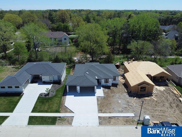 birds eye view of property featuring a wooded view and a residential view
