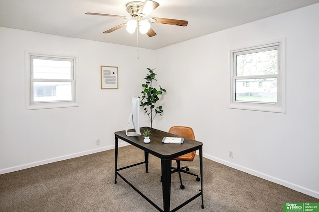 office area featuring dark carpet, a ceiling fan, and a wealth of natural light