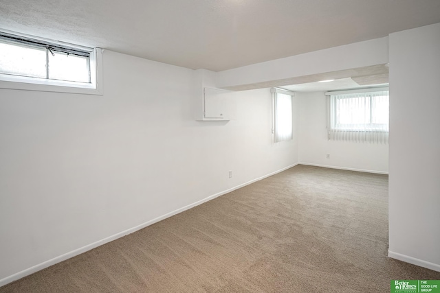 basement with baseboards and carpet