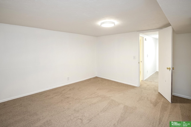 carpeted spare room with baseboards