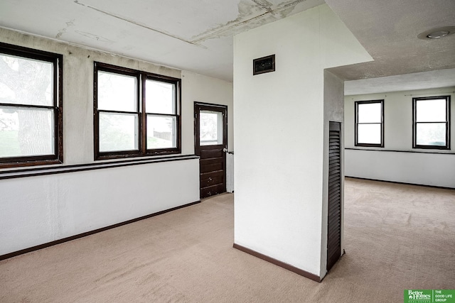 carpeted empty room with baseboards