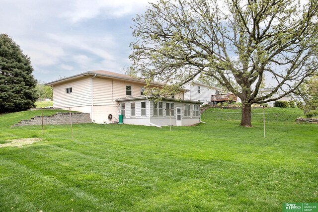 back of house featuring a lawn
