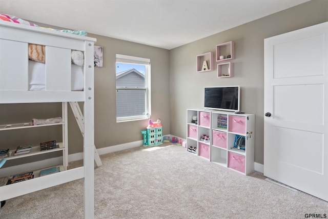 bedroom featuring carpet and baseboards