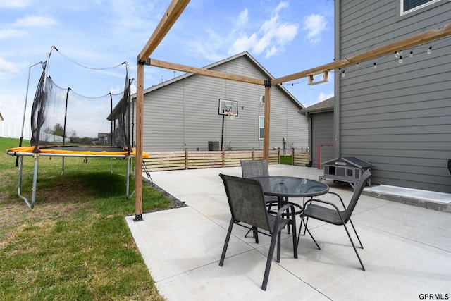 view of patio / terrace with a trampoline and outdoor dining space