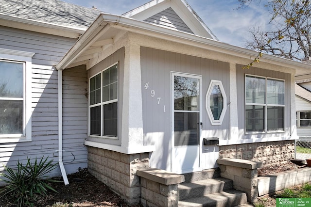 view of home's exterior with roof with shingles and entry steps