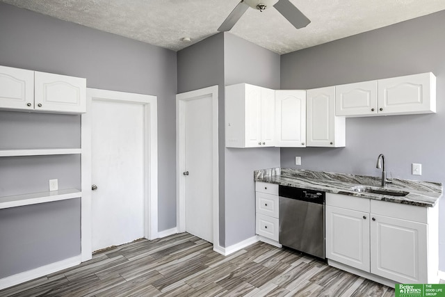kitchen featuring light wood-style floors, stone countertops, ceiling fan, a sink, and dishwasher