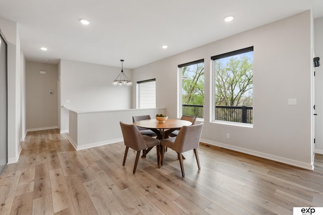 dining area featuring baseboards, recessed lighting, light wood-style flooring, and a notable chandelier