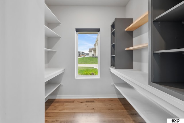 spacious closet with wood finished floors and visible vents