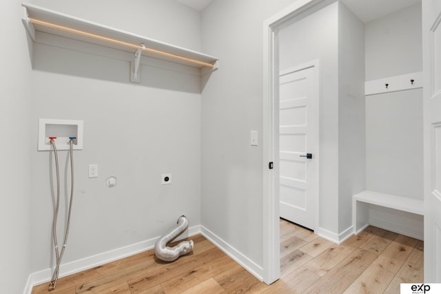 washroom featuring washer hookup, hookup for an electric dryer, laundry area, baseboards, and light wood finished floors