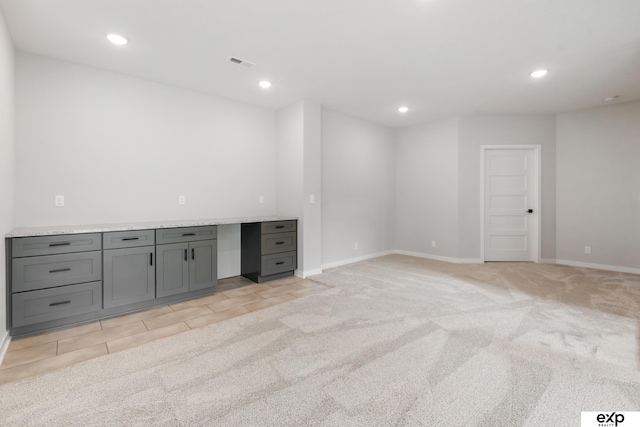 interior space with light colored carpet, baseboards, visible vents, and recessed lighting