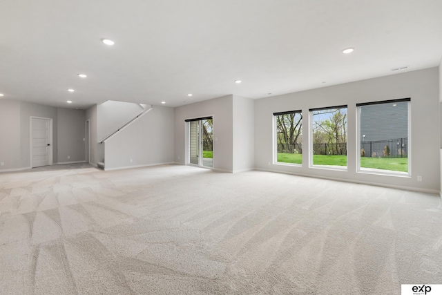empty room with recessed lighting, baseboards, and light carpet