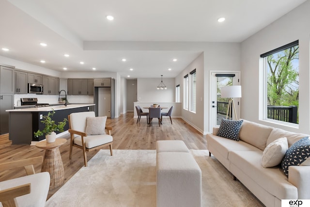 living room with recessed lighting, plenty of natural light, and light wood-type flooring