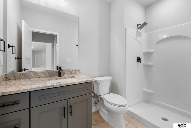 full bath with vanity, tile patterned floors, a stall shower, and toilet