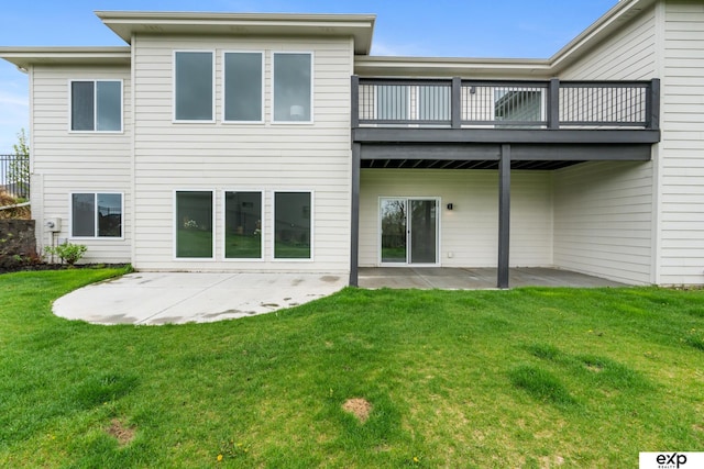 back of property featuring a yard, a patio area, and a balcony