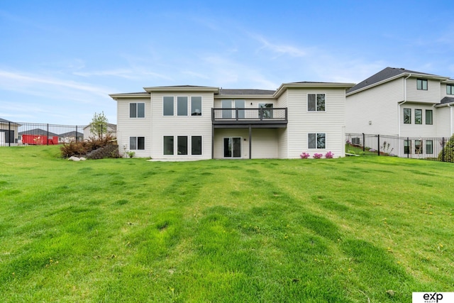 rear view of property with a lawn and fence