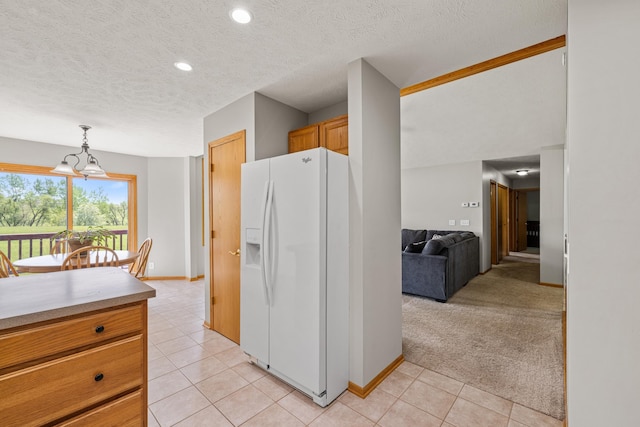 554 Shawnee Blvd, Tecumseh, NE 68450 - kitchen with white fridge with ice dispenser, light tile patterned flooring, a textured ceiling, recessed lighting, and baseboards