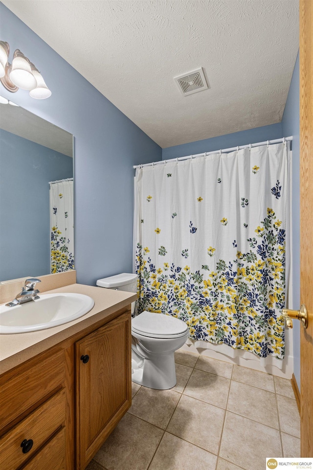 554 Shawnee Blvd, Tecumseh, NE 68450 - bathroom with toilet, vanity, tile patterned floors, and a textured ceiling